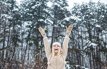 Happy girl raised her hands up. Christmas time.