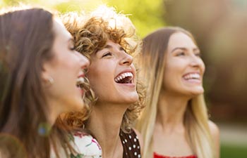 Group of three female friends having fun together.