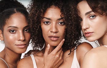 Close up beauty portrait of three attractive young sensual multiethnic women.